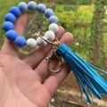 Detail of blue and marble silicone bead wristlet with gold clasp and leather tassel - Style 14-Blue Sky Blue Marble White/Bright Blue Tassel