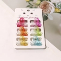 Detail view of six colorful mini butterfly hair clips on a white fashion jewelry card - Gradient Clover