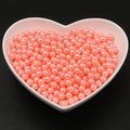 Vibrant bright pink ABS round faux pearls in a white heart bowl for DIY crafts - Orange Pink