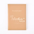 Close-up of light brown PU leather passport cover with gold embossed adventure quote - Ginger Yellow