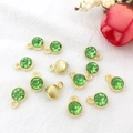 Twelve gold zodiac pendants with green faceted stones and diamond accents for DIY jewelry - Gold August - Light Green