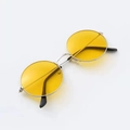 Detail shot of vintage round silver metal sunglasses featuring translucent yellow lenses - Silver Frame Yellow Lens