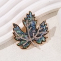 Elegant maple leaf brooch featuring iridescent blue-green shell and sparkling rhinestones - Blue Green Iridescent Maple Leaf