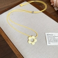 Detail of yellow flower pendant necklace with adjustable cord on rustic wooden tray - Yellow Dopamine Hollow Flower Pendant Necklace