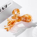 Elegant amber tortoiseshell acetate shark hair claw clip with a glossy wing design - Orange Red Spotted