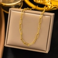 Elegant gold paperclip link bracelet displayed on a beige leather jewelry box - Paperclip Cross Chain (AH201) / Gold