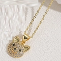 Macro detail of a gold puppy pendant necklace with sparkling white and black crystals - Upright Ears White Zirconia (Gold)