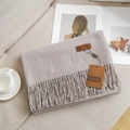 Oatmeal color cashmere-feel scarf with tassels and leather tag on beige sofa - 40# Shrimp Pink