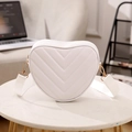 White heart-shaped crossbody bag with V-quilted texture and gold-tone metal hardware - White