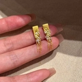 Gold leaf tassel earrings with frosted texture and zircon stones held by hand - Gold (S925 Silver Pin)