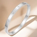 Macro shot of silver titanium steel bangle with floral diamond inlay ornaments - Four-Leaf Flower Bangle (TT0095) / Steel