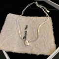Close-up of silver double-layered blade chain necklace with a 3D water drop pendant - Silver Water Drop Double Blade Chain