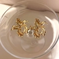 Macro shot of gold floral earrings with vintage texture in an artistic glass bowl - Gold Vintage Iris Flower (4#)