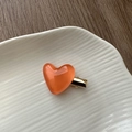 Detail of an orange translucent heart-shaped hair clip with a gold metal duckbill clamp - Jelly Heart Hair Clip-Orange