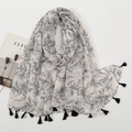 Detailed flat lay of beige scarf with black lily flower prints and fringe trim detail - Cream Black Lily Style (XB946-01)