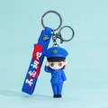 Cartoon policewoman PVC keychain in blue uniform with red strap and metal clasp - Air Force Salute Female Soldier