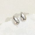 Minimalist silver teardrop earrings with a polished mirror finish on a stone display - Smooth Waterdrop Earrings / Platinum Color