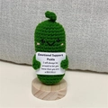 Close-up of handmade crochet emotional support pickle on a round wooden base - No.1 Cucumber 12cm