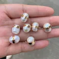Baroque pearl pendant set with gold metal rings held in hand, natural jewelry accessories - No.43 Width 10-11mm