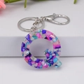 Resin letter Q keychain featuring colorful stones and a silver metal clasp - Letter Q