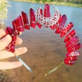 Detailed close-up of a handmade silver crescent moon crown with faceted red crystals - Burgundy
