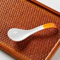 Japanese style orange ceramic soup spoon with curved handle, size 16cm by 4.5cm - Orange & Yellow