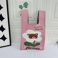Pink knitted tote bag featuring a cute brown bear flower pattern and Lucky Happy text - Pink Floral