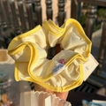 Cream large scrunchie with yellow trim and pink bear charm detail outdoors - Yellow Trim Cream White Scrunchie with Pink Button