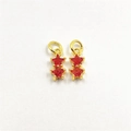 Close-up of golden star-shaped pendants with red cubic zirconia for jewelry DIY making - Brilliant Red