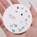 Detailed close-up of 7-pair stud earrings set with blue rhinestones and whale charms - 7 Pairs Set / E0570-1 (Silver Blue Whale Starfish Set)