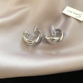 Detail view of silver twisted hoop clip-on earrings with comfortable silicone pads - Silver