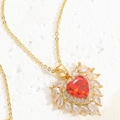 Macro detail of luxury heart-shaped red zircon pendant with marquise white diamond halo - Red Main Stone with Halo Pendant / Red Heart Zirconia