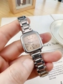 Close-up of elegant square silver ladies watch held over a lifestyle background - Beige