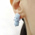 Close-up of cute light blue hippo earring biting earlobe with matte finish design - Blue Hippo