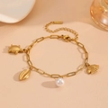 Detail of gold turtle, seashell and fish charms bracelet with a lustrous white pearl - Clownfish Sea Turtle Beach Bracelet (T707)