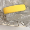 Detail showing bright yellow fabric hair clip with twill texture in a white gift basket - Yellow
