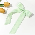 Detail of mint green satin bow hair clip with ruffled edges and long flowing ribbons - Light Green