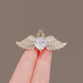 Golden heart zircon brooch with wings and crown shown held between fingers - 280# Angel Wings