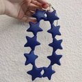 Blue silicone star keychain accessory with gold metal clasp shown in a handheld view - Navy Blue (10 Stars)