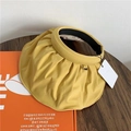 Close-up detail of a yellow pleated shell sun visor hat with a flexible open top design - One Size / Yellow