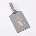 Close-up of grey PU leather luggage tag featuring a gold foil world map and metal buckle - Gray