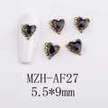 Macro shot of 5.5x9mm heart-shaped gothic nail charms with vintage gold wing frames - AF27-Gold Edge Black Gem Heart