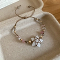 Detail of bohemian woven bracelet featuring white star crystal and pink natural stone beads - White Crystal Star Pendant / Coffee-White