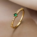 Detailed close-up of 18K gold plated ring with green zircon and white accent stones - Adjustable Open / Gold with Green Stone