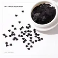 Vista macro di paillettes nere a forma di cuore 3mm per nail art e DIY in contenitore bianco - Paillettes Cuore-001 Nero / Nero
