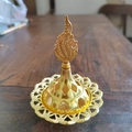Detailed close-up of golden hollowed-out metal incense burner with Middle Eastern floral patterns - Large Pointed Head