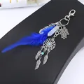 Detailed view of the Hamsa Hand and dreamcatcher charms on blue feather keychain - Style 7