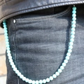 Sky blue turquoise beaded wallet chain accessory shown on black denim trousers - Turquoise