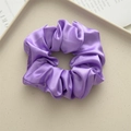 Lavender purple satin scrunchie with silky finish on a beige textured tray - Lilac Purple