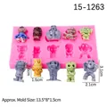 Pink silicone mold with halloween skulls and ghosts, including colorful finished resin shapes - Pink